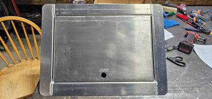aluminum in floor winch box with the lid closed on a table top