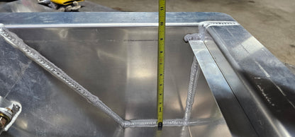 aluminum in floor winch box with a tape measure indicating that the inside depth of the box is 10" deep. The lip that holds the lid in place is set at a depth of 9"