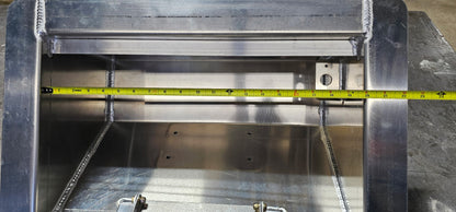 aluminum in floor winch box with the lid off showing a tape measure indicating the inside opening of the box is 20" wide